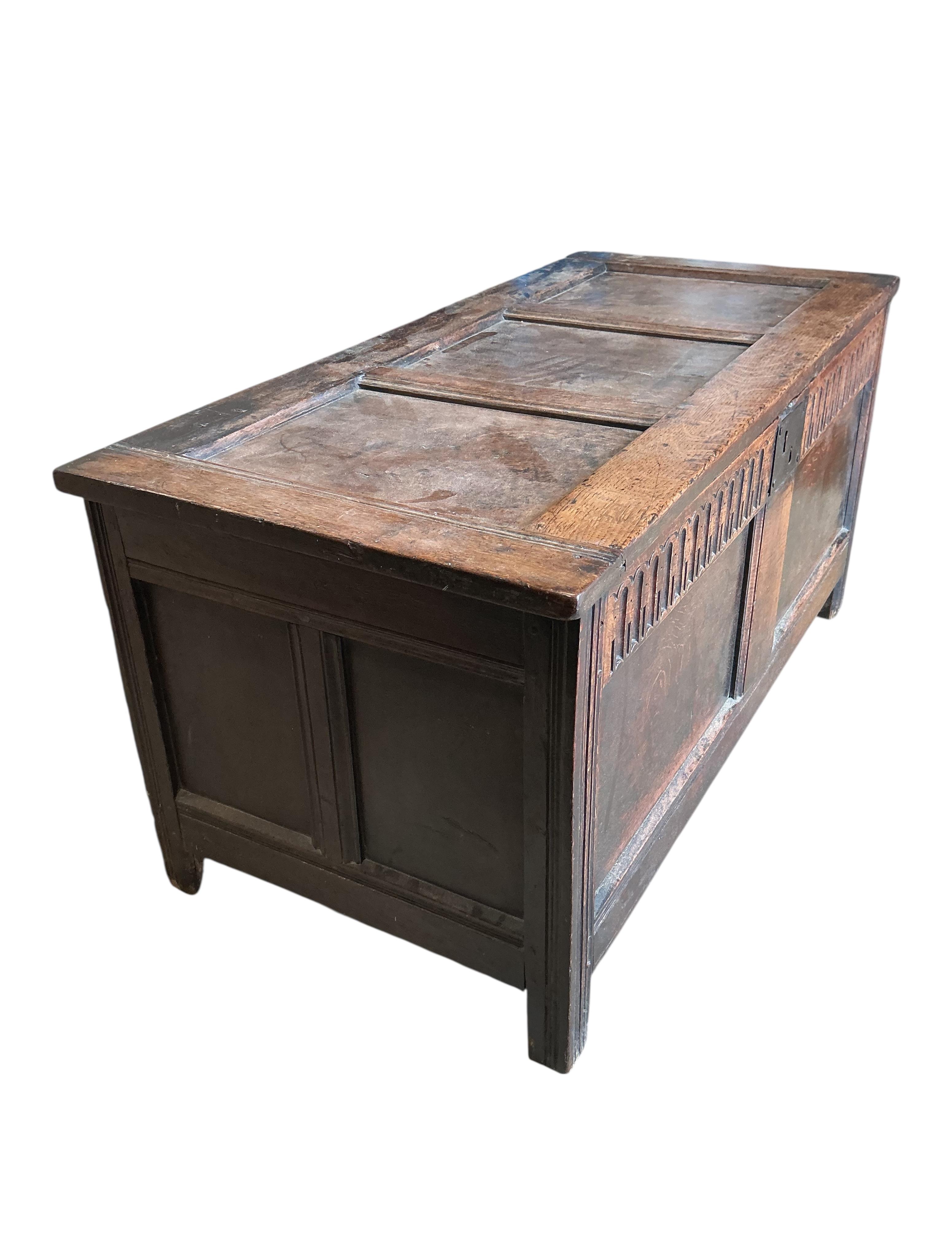 A 17th century panelled oak coffer, width 121cm, depth 57cm, height 58cm